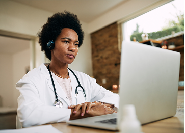Doctor with headset conducting telehealth consultation